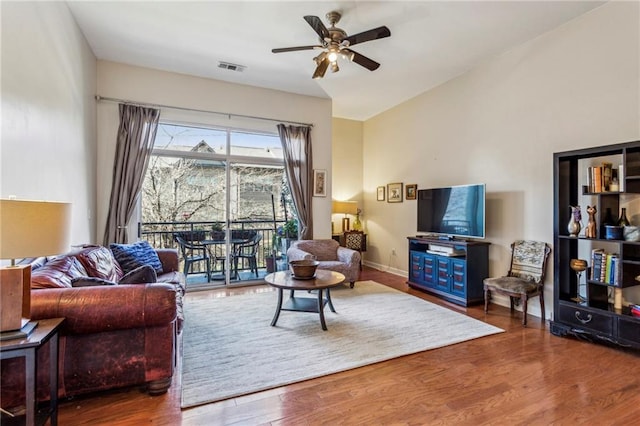 living room with ceiling fan and wood-type flooring