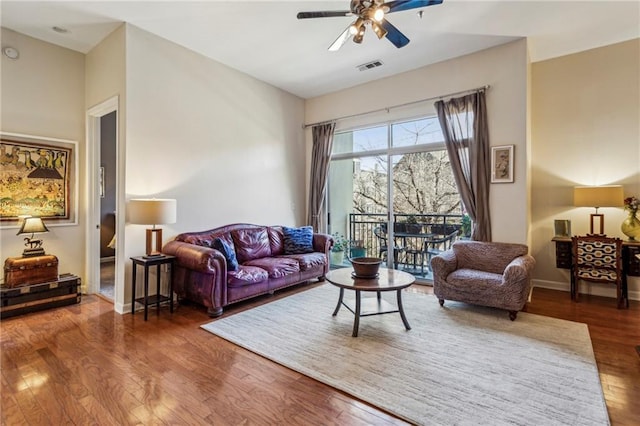 living room with ceiling fan and dark hardwood / wood-style floors