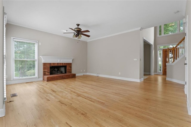 3642 Fowler Rdg, Douglasville, GA 30135 - unfurnished living room featuring light wood-style floors, healthy amount of natural light, a ceiling fan, baseboards, and ornamental molding