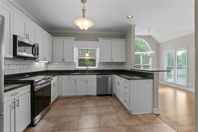 3642 Fowler Rdg, Douglasville, GA 30135 - kitchen featuring appliances with stainless steel finishes, white cabinetry, a peninsula, tasteful backsplash, and a sink