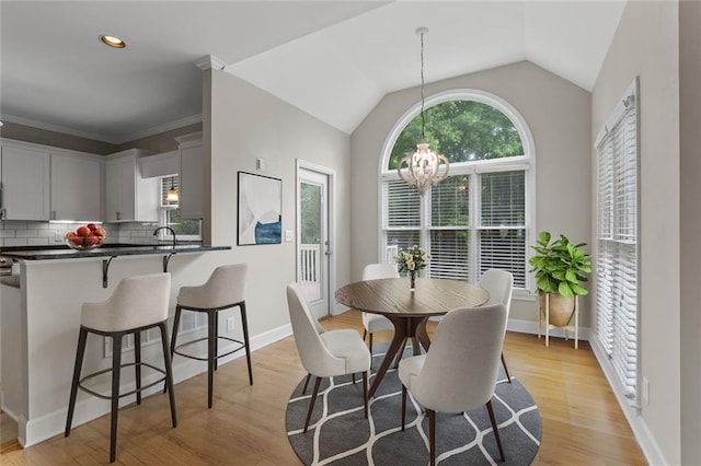 3642 Fowler Rdg, Douglasville, GA 30135 - dining space with a chandelier, light wood-style flooring, lofted ceiling, and baseboards