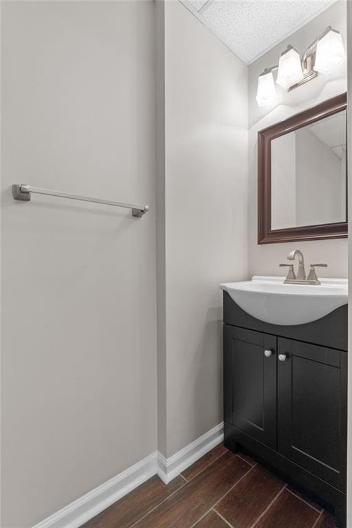 3642 Fowler Rdg, Douglasville, GA 30135 - bathroom featuring wood finished floors, vanity, and baseboards