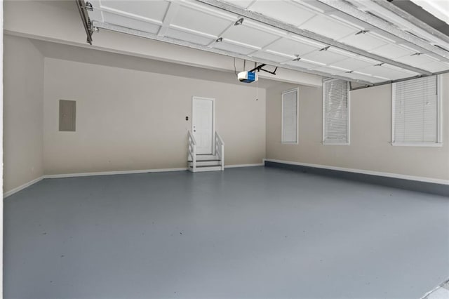 3642 Fowler Rdg, Douglasville, GA 30135 - garage featuring baseboards, a garage door opener, and electric panel