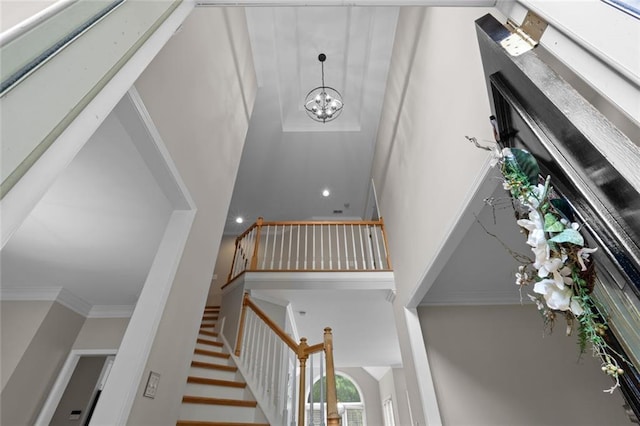 3642 Fowler Rdg, Douglasville, GA 30135 - stairs featuring a towering ceiling, crown molding, and a chandelier
