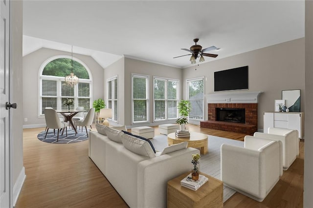3642 Fowler Rdg, Douglasville, GA 30135 - living area featuring plenty of natural light, ceiling fan, light wood-style floors, a fireplace, and vaulted ceiling
