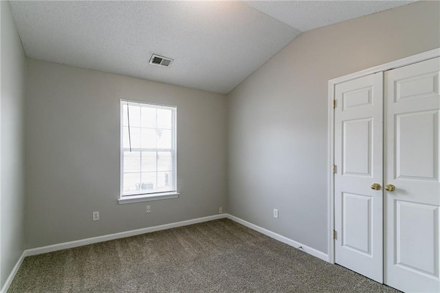 256 Turnstone Rd, Stockbridge, GA 30281 - carpeted empty room with baseboards, a textured ceiling, and vaulted ceiling