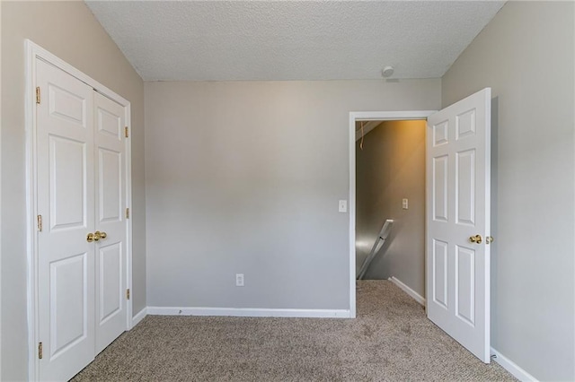256 Turnstone Rd, Stockbridge, GA 30281 - unfurnished bedroom featuring carpet flooring, a textured ceiling, and baseboards