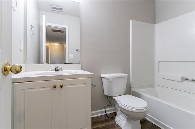 256 Turnstone Rd, Stockbridge, GA 30281 - bathroom with toilet, vanity, baseboards, wood finished floors, and shower / tub combination