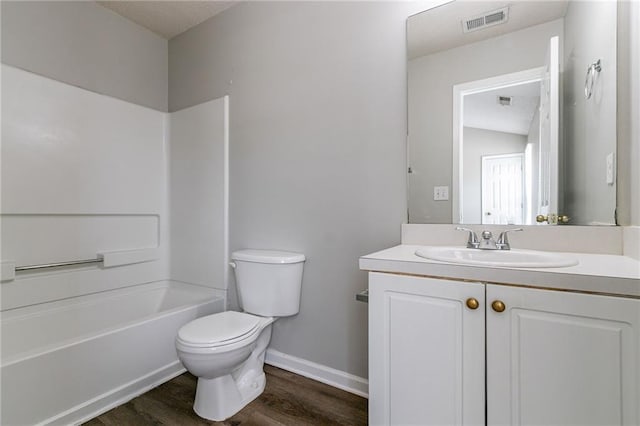 256 Turnstone Rd, Stockbridge, GA 30281 - bathroom with toilet, vanity, wood finished floors, washtub / shower combination, and baseboards