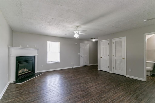 256 Turnstone Rd, Stockbridge, GA 30281 - unfurnished living room with a textured ceiling, wood finished floors, ceiling fan, baseboards, and a fireplace with raised hearth
