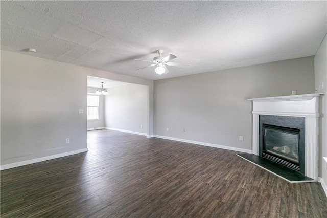 256 Turnstone Rd, Stockbridge, GA 30281 - unfurnished living room with dark wood finished floors, a glass covered fireplace, ceiling fan, a chandelier, and a textured ceiling