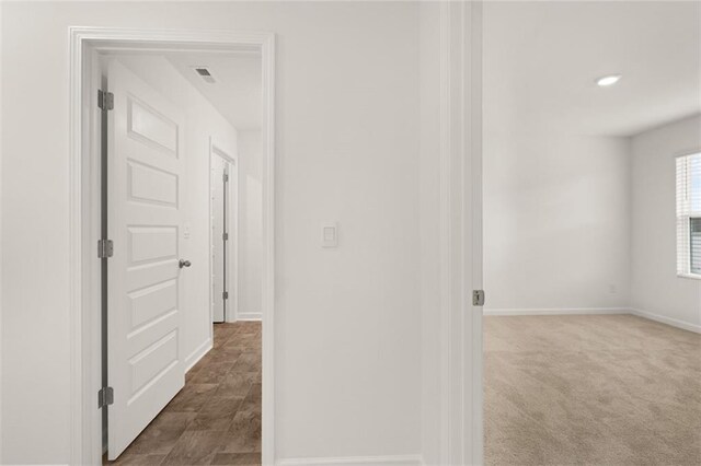 hallway with carpet floors