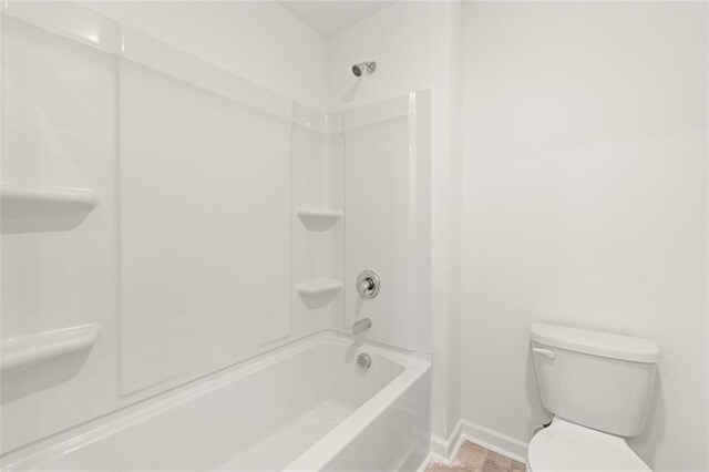 bathroom featuring toilet and shower / bathtub combination