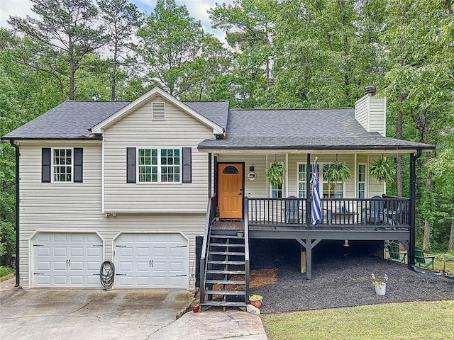 tri-level home featuring a porch, an attached garage, a chimney, and roof with shingles