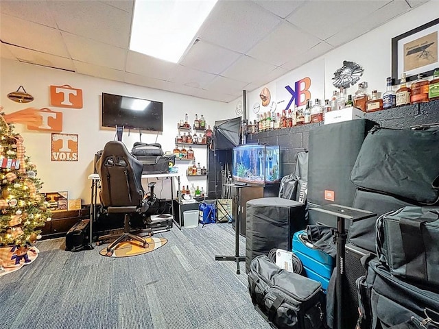 miscellaneous room featuring carpet, a bar, and a paneled ceiling