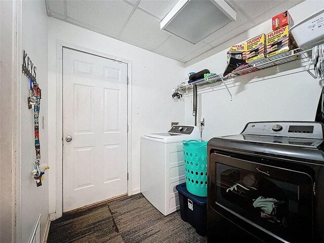 washroom featuring visible vents, laundry area, dark colored carpet, and washer and clothes dryer