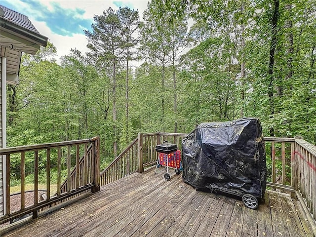 wooden deck with a wooded view