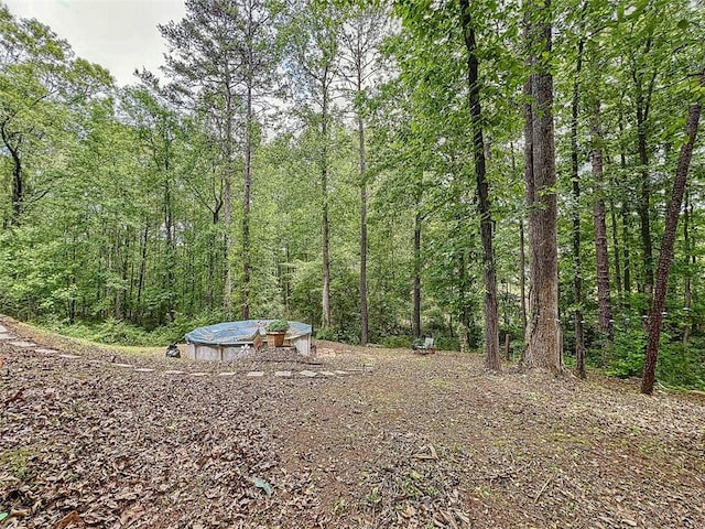 view of yard with a view of trees