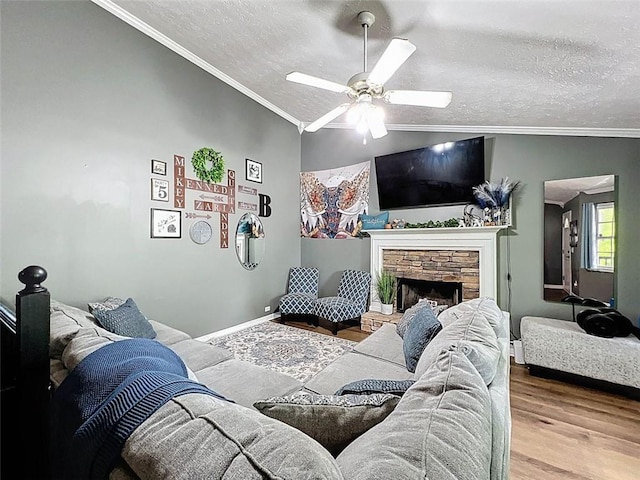 living area with a ceiling fan, a textured ceiling, wood finished floors, and vaulted ceiling
