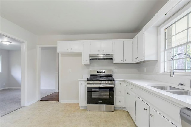 2110 Redbud Ct SW, Marietta, GA 30008 - kitchen featuring gas range, under cabinet range hood, dishwashing machine, white cabinetry, and light countertops