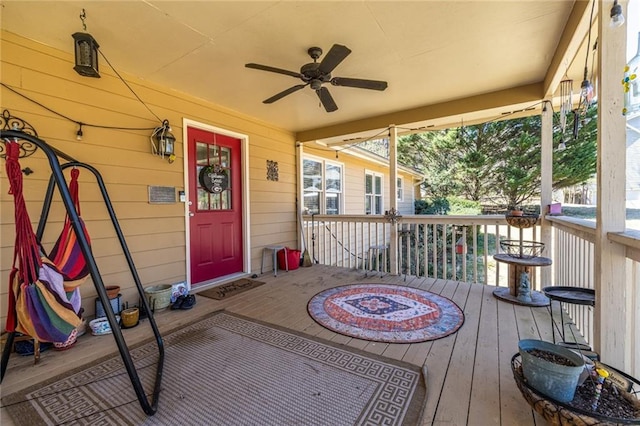 wooden terrace featuring a ceiling fan