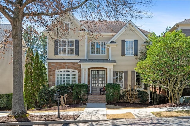 view of front of house with french doors and stone siding