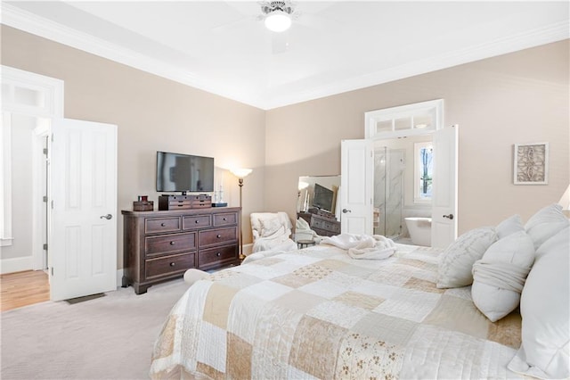 bedroom with baseboards, ceiling fan, ensuite bathroom, crown molding, and light colored carpet