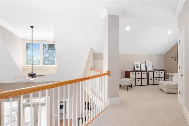 corridor with baseboards, crown molding, lofted ceiling, and carpet floors