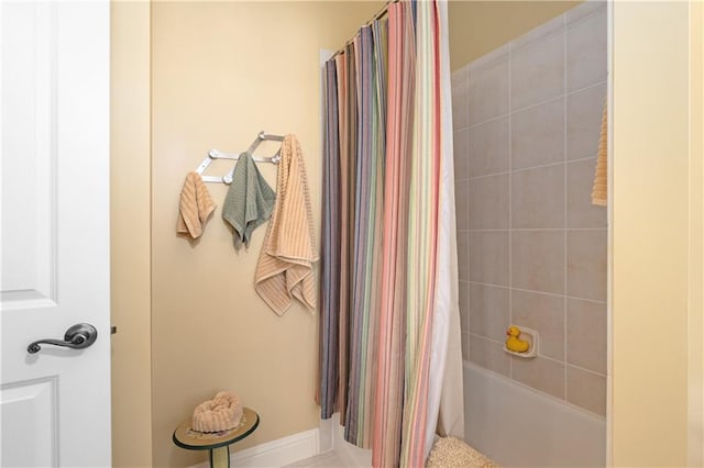 bathroom with shower / bathtub combination with curtain