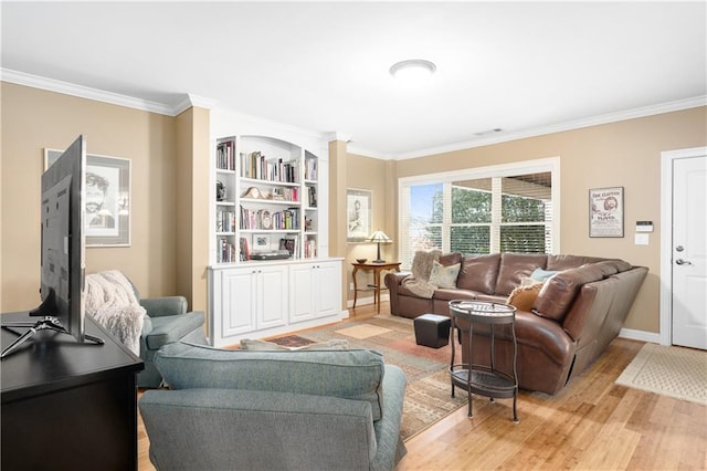 living room featuring light wood-type flooring, baseboards, and crown molding