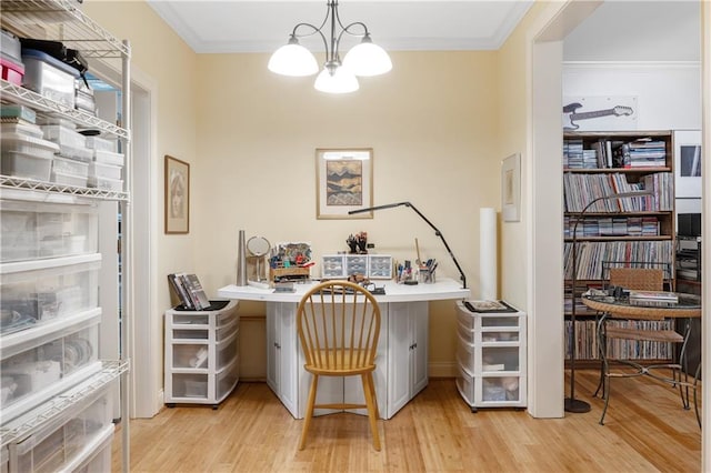 office space featuring light wood finished floors, crown molding, and an inviting chandelier