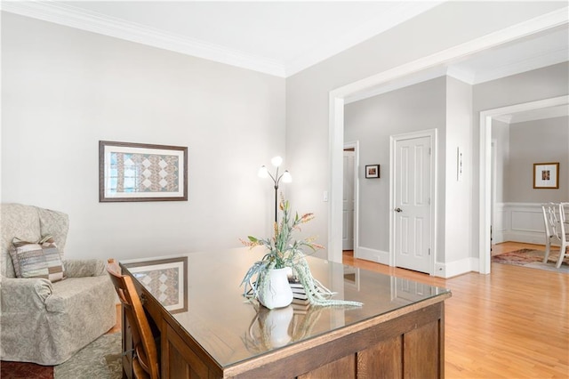 office space with light wood-type flooring and ornamental molding