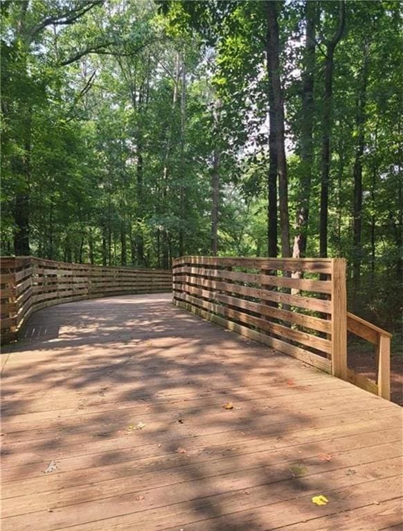 wooden deck with a forest view