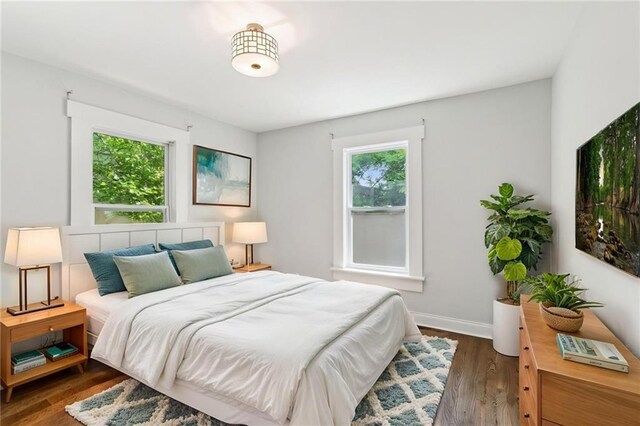 bedroom featuring baseboards and wood finished floors