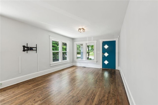 interior space featuring baseboards and wood finished floors