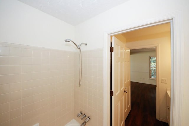 bathroom with wood-type flooring and shower / bath combination