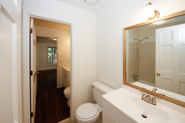 full bathroom featuring hardwood / wood-style flooring, vanity,  shower combination, and toilet