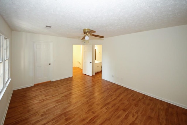 unfurnished room featuring hardwood / wood-style flooring, ceiling fan, and a textured ceiling