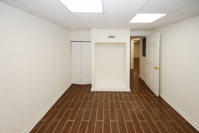 interior space with a paneled ceiling