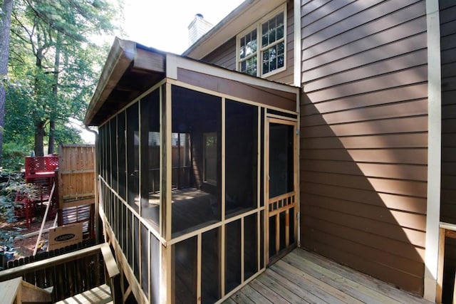 wooden deck with a sunroom