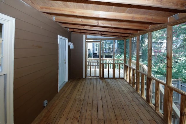 unfurnished sunroom with vaulted ceiling with beams and wood ceiling