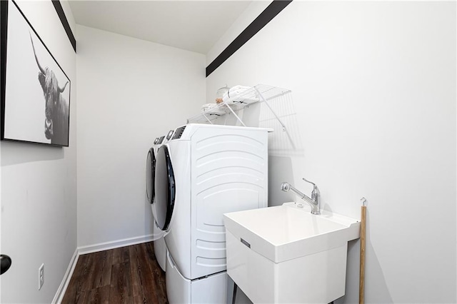 washroom featuring washer and dryer, sink, and dark hardwood / wood-style flooring