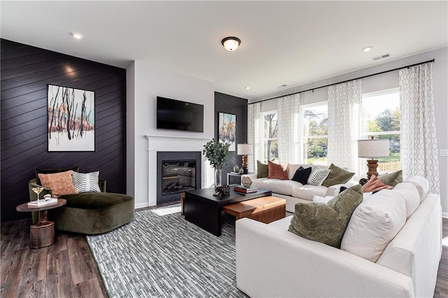 living room featuring hardwood / wood-style floors and wood walls