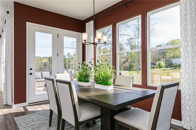 dining space featuring an inviting chandelier and hardwood / wood-style flooring