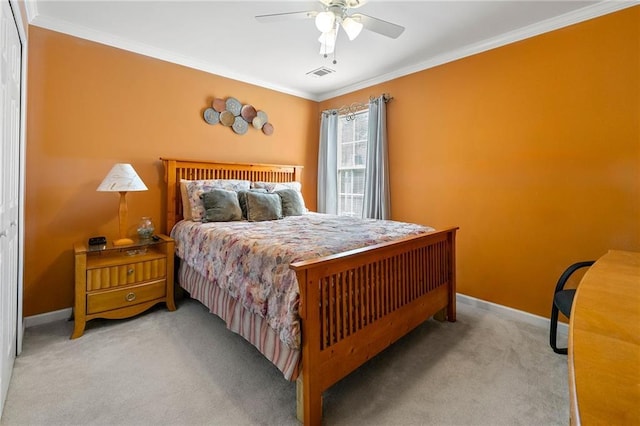 carpeted bedroom with baseboards, visible vents, crown molding, and a ceiling fan