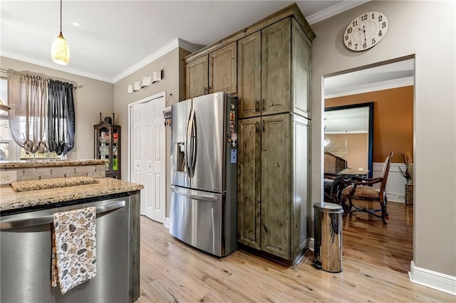 kitchen with hanging light fixtures, light wood-type flooring, crown molding, and appliances with stainless steel finishes