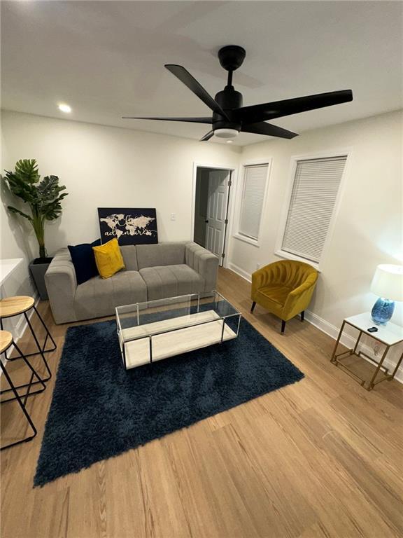 living area featuring recessed lighting, baseboards, a ceiling fan, and wood finished floors