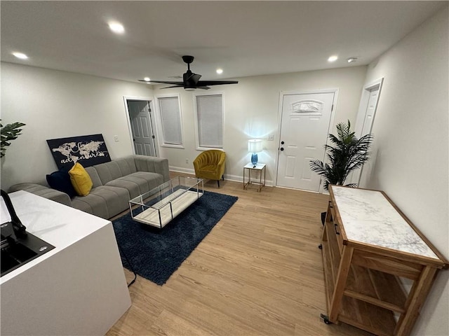living room featuring recessed lighting, baseboards, light wood finished floors, and ceiling fan