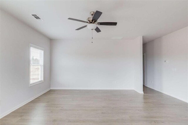 empty room featuring ceiling fan and light wood-type flooring