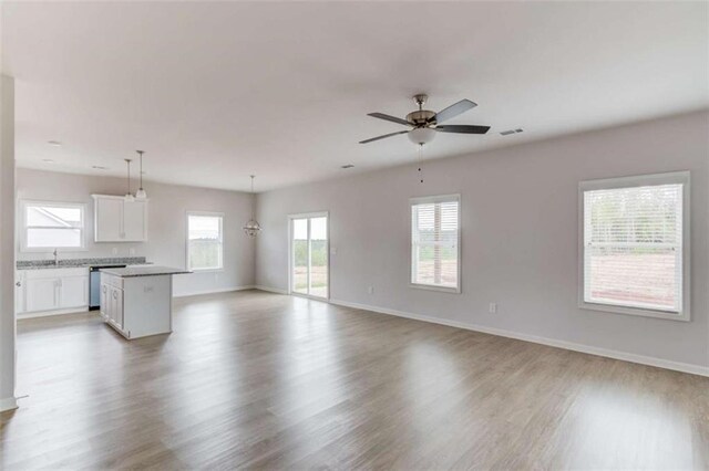 unfurnished living room featuring hardwood / wood-style floors and ceiling fan